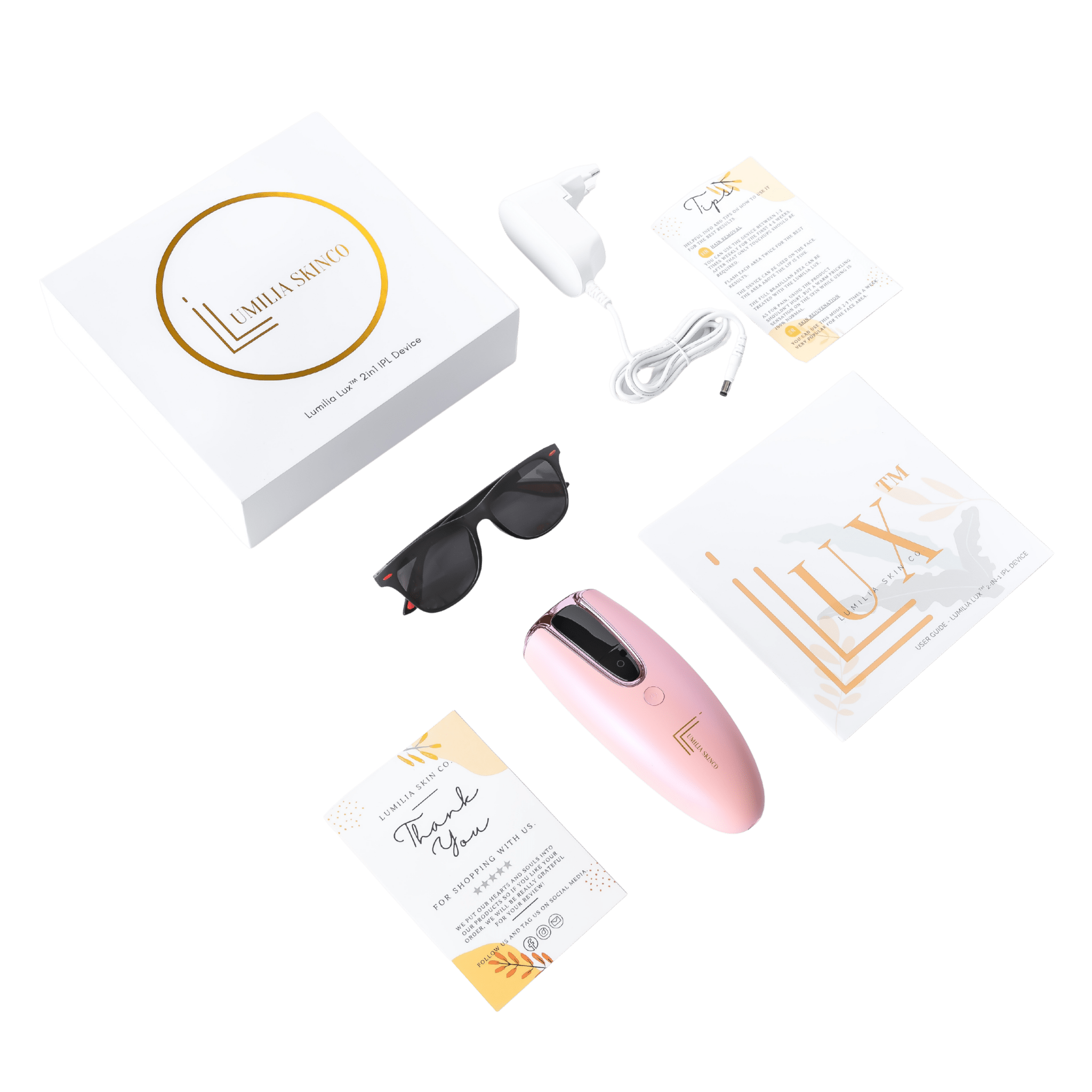 Pink Lumilia Lux™ 2-in-1 IPL device with rose gold trim and complete kit — protective sunglasses and accessories included.
